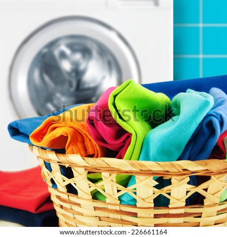 Pile of colorful clean clothes with washing machine.