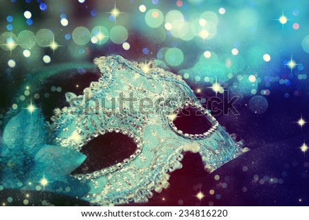 Carnival mask on black silk background.