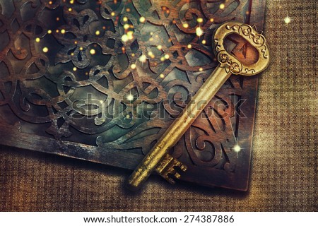 Magic book with gold vintage key