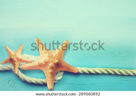 Starfish and rope. Blue marine background.