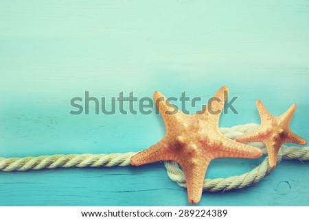 Starfish and rope. Blue marine background.