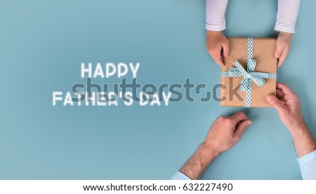 Son gives a gift to dad. Father\'s Day.
