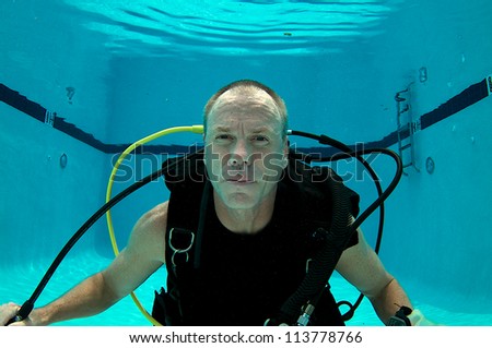 Scuba Diver in a pool with no mask or regulator