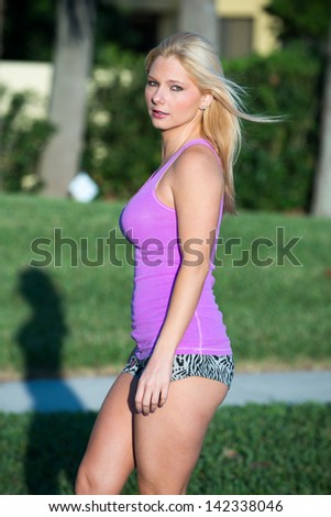 Pretty blond haired model on in line skates.