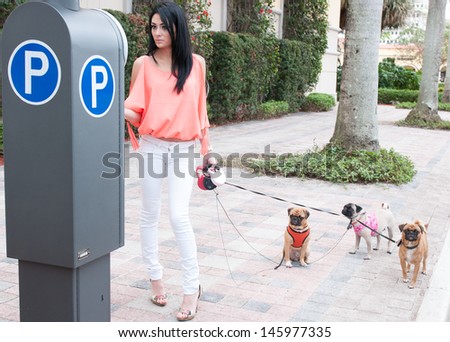 A woman and her three dogs out for a walk