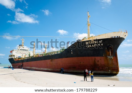 Songkhla, Thailand - March 01:Traveller sightseeing the Ships ORAPIN 4 is a liquefied natural gas tanker. The ship hit by Waves crashing ashore.On March 01,2014 at Samila Beach, Songkhla, Thailand.
