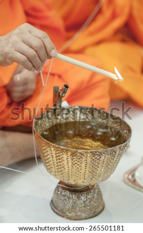 Close up monk do holy water in wedding ceremony
