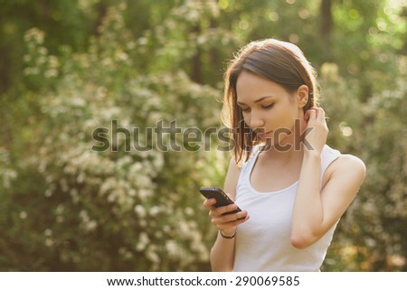 Portrait of young girl, dialing the number