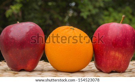 One orange and two apple background