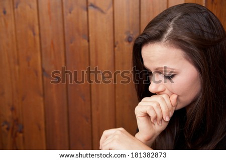 Tearful Young Woman With Head In Hands