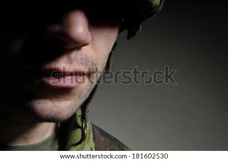 Soldier With Face In Shadow