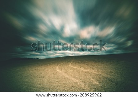 vintage landscape with field and clouds