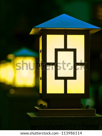 Few yellow lanterns in dark.