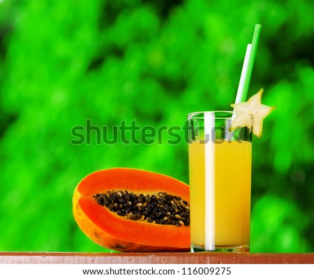 Glass of papaya juice in a garden.