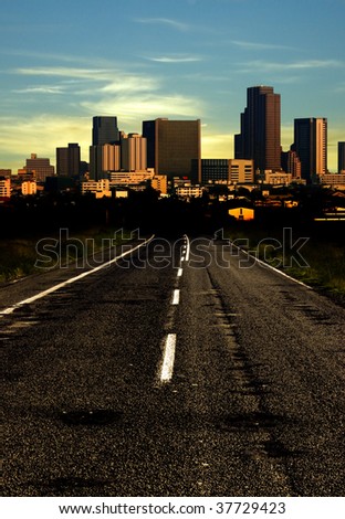 long road to city in dusk