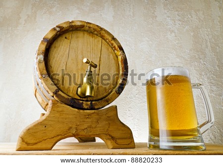 Beer and barrel on the wood table.