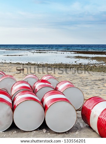 Lot of oil barrels on a seashore. Environment pollution.