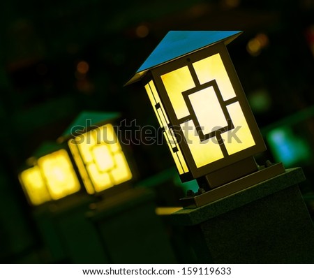 Few yellow lanterns in dark.