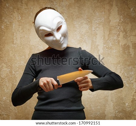 Woman in white mask holding the knife.