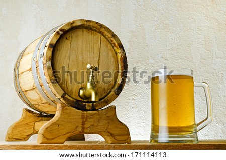 Beer and barrel on the wood table.