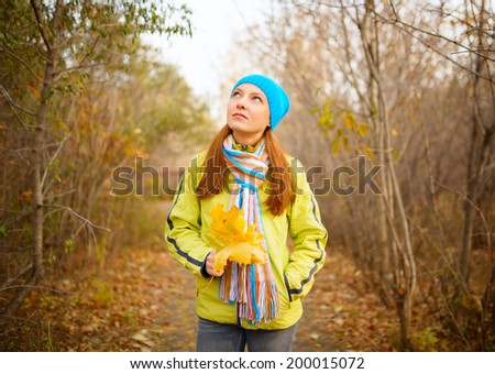 Young woman walking in the fall season. Autumn outdoor portrait.