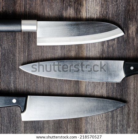 Knives on wooden board. Cooking concept.