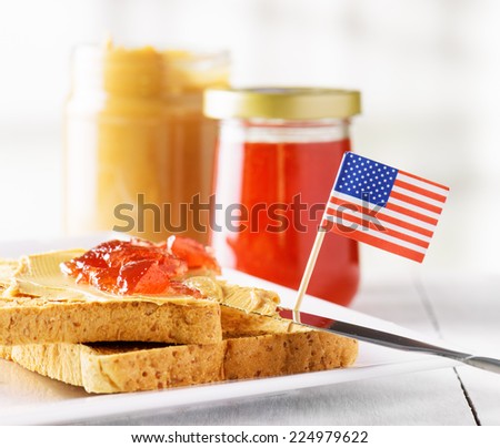 Toasts with peanut butter and strawberry jam on white table. American breakfast.