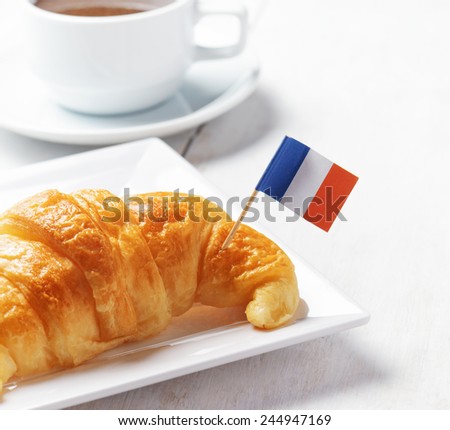 Cup of coffee and croissant in Paris. French cafe.