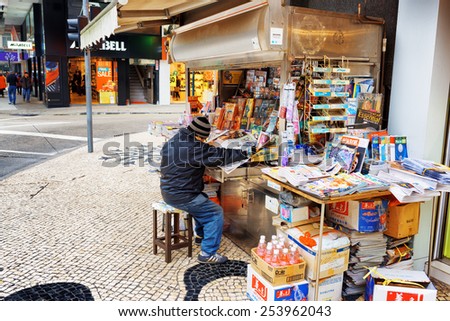 MACAU - JANUARY 30, 2015: Street vendor of newspapers in Macau. Macau is a popular tourist attraction of Asia and leading casino market of the world.