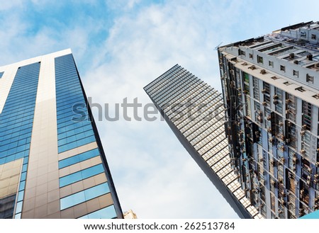 HONG KONG - JANUARY 31, 2015: Bottom view of skyscrapers in business center of Hong Kong. Hong Kong is popular tourist destination of Asia and leading financial centre of the world.