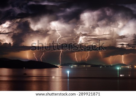Beautiful view of dramatic dark stormy sky and lightning over Nha Trang Bay of South China Sea in Khanh Hoa province at night in Vietnam. Nha Trang city is a popular tourist destination of Asia.