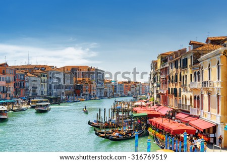 Beautiful view of the Grand Canal with gondolas from the Rialto Bridge (Ponte di Rialto) in Venice, Italy. Venice is a popular tourist destination of Europe.