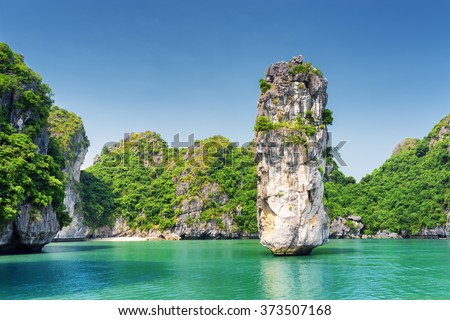 Amazing rock pillar and azure water in the Ha Long Bay (Descending Dragon Bay) at the Gulf of Tonkin of the South China Sea, Vietnam. The Halong Bay is a popular tourist destination of Asia.