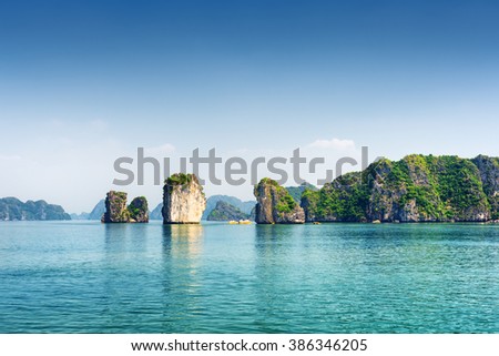 Azure water of the Ha Long Bay at the Gulf of Tonkin of the South China Sea, Vietnam. Scenic view of blue lagoon and karst towers-isles. The Halong Bay is a popular tourist destination of Asia.