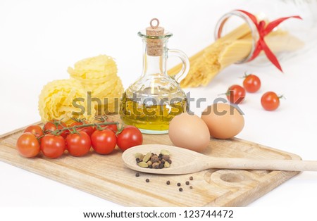 Tagliatelle, cherry tomatoes, eggs, olive oil and spices for cooking Italian dishes