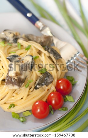 Spaghetti sauce with wild mushrooms, cherry tomatoes and green onions