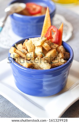 Small pieces of garlic bread with herbs in a small bowl