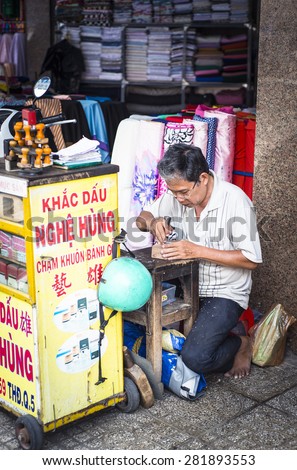 HO CHI MINH CITY, MAY 24 2015 - A man carving seals at Cho Lon SaiGon