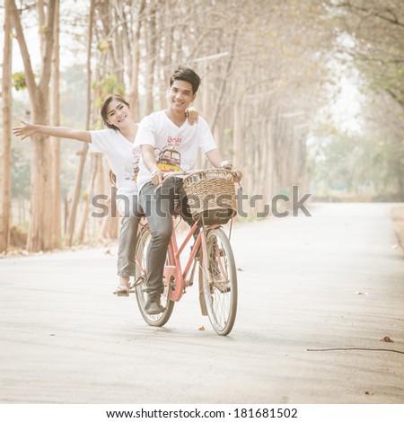 A short of loving couple riding on bike in the nature
