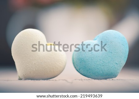macarons in heart shape on wood table,vintage tone style