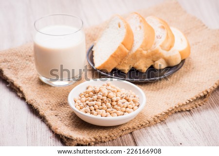Soybeans and soy milk in a glass with fresh buns. selective focus is soybeans