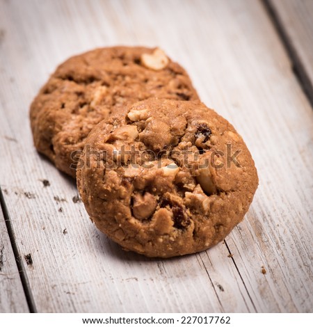 Stack of Chocolate chip cookies on wooden background. Stacked chocolate chip cookies shot with selective focus.