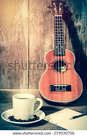 coffee cup and coffee beans and Ukulele with papernote ;vintage filtered style