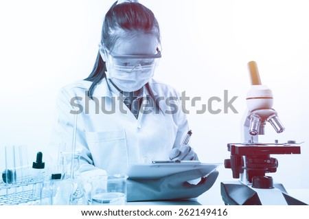 scientist writing report with equipment and science experiments with lighting effect vintage style