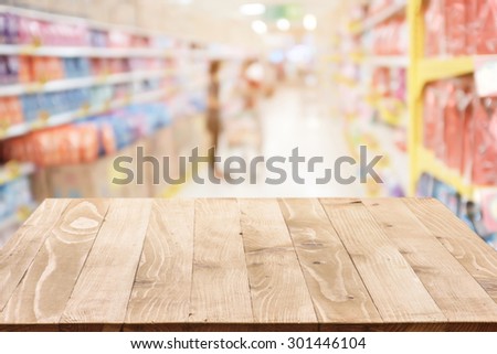 Empty wood table top (or shelf) on Blurred shopping mall background - can montage or display your products