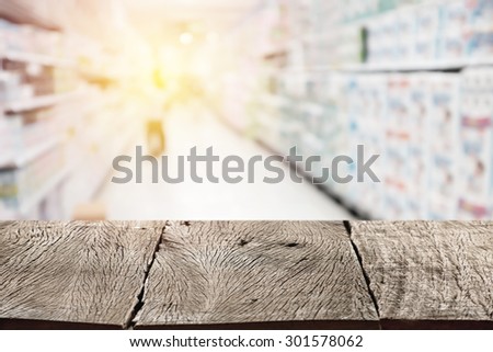 Empty wood table top (or shelf) on blurred shopping mall background