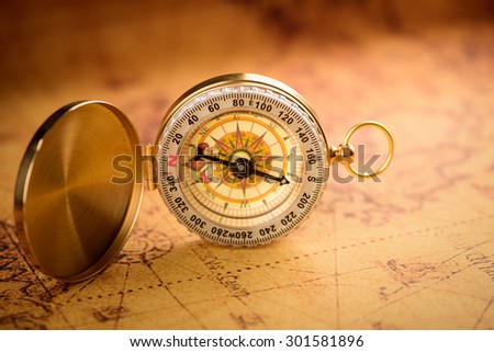 Old  gold vintage compass on vintage map