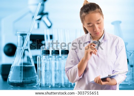scientist or doctor thinking for writing report with equipment and science experiments