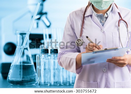 scientist or doctor writing report with equipment and science experiments