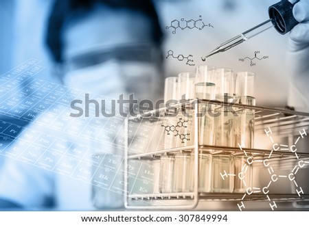 Investigator checking test tubes. Man wears protective gogglesÃ Â¸Â¡researcher is testing, dropping reagent to test tube at laboratory with chemical equations and periodic table background.